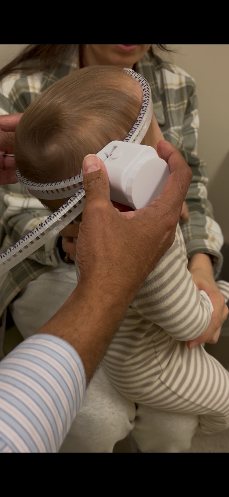 Infant head circumference measurement device in use