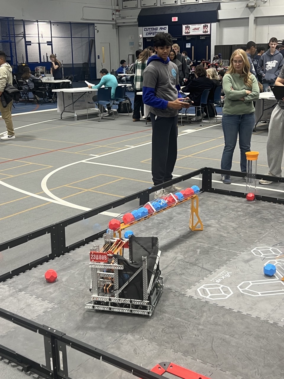VEX robotics competition with robot on field